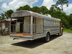 an old bus is parked in the dirt