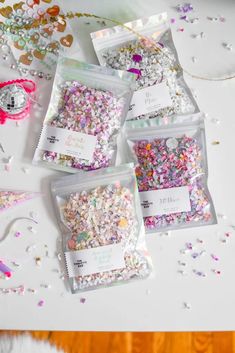 five bags of confetti on a table with confetti sprinkles