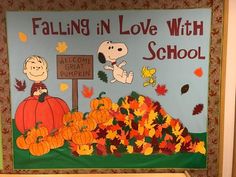 a bulletin board with peanuts and pumpkins on it that says falling in love with school