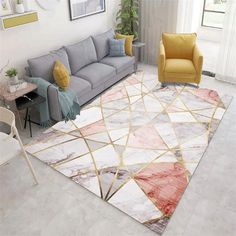 a living room filled with furniture and a rug on top of a hard wood floor