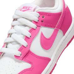 This Nike Dunk features a leather upper boasts a harmonious blend of white and laser fuchsia, with the striking shade accentuating the mudguard, eyestays, iconic Swoosh, and tongue tag. Meanwhile, the foundational elements are kept clean in white, which extends to the laces, tongue, sockliner, and heel. Completing the striking design is the white midsole and laser fuchsia rubber outsole. All Jordans, Nike Models, Jordan 11 Retro, Cute Nikes, Vans Shop, Nike Kids, Jeans For Short Women, Kids Socks, Nike Dunk Low