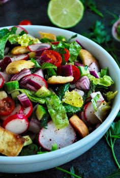 a salad with radishes, lettuce and other vegetables