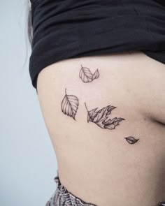 a woman's stomach with three leaves on the side and one in the middle