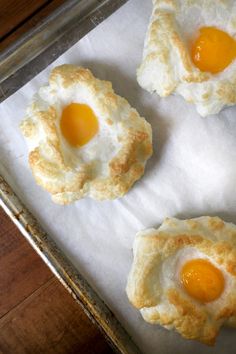 three fried eggs are on top of some bread