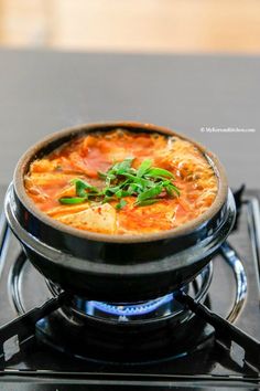 a small pizza sitting on top of a stove