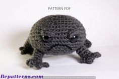 a crocheted gray frog sitting on top of a white table next to the words pattern pdf