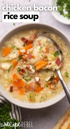 chicken bacon rice soup in a white bowl with a spoon and bread on the side