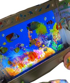 a child is playing with an interactive fish tank