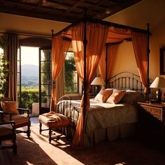 a bedroom with a four poster bed and orange drapes on the windowsills