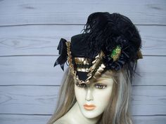 Beautiful ladies black tricorn with golden tan satin pleated trim with black and gold braid. Black cocarde with a hand painted floral accent, black ostrich feathers and black satin bows. Please measure your head before purchasing as I do not take returns and all sales are final. The inside circumference is 22.5" with a built-in adjustable string. Just cinch and tie for a better fit. Perfect for Renaissance Fairs, Gasparilla Pirate event, 1800's Victorina events or even Halloween. Check out my other hats and fascinators in my shop. Please let me know if you have any questions.   All sales are FINAL, no returns or exchanges please keep this in mind before purchasing. 1800s Style, Tricorn Hat, Pirate Hat, Satin Noir, Golden Tan, Pirate Hats, Costume Hats, Ostrich Feathers, Beautiful Ladies