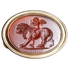 This exquisite intaglio is masterfully engraved onto carnelian and features Eros (Cupid) riding a lion. The motif in art is often accompanied by the Latin phrase, "Omnia vincit amor” or "Love conquers all”. The composition is engraved onto carnelian and set in an 18K gold signet ring. Production time for this piece is 12-14 weeks. Can be made in any size ranging from 6-12 Chavdar Chushev is an artist, restorer, jeweler, and master of the ancient art of gem carving. His extensive knowledge of gem Gem Carving, Ancient Jewels, Gold Finger Rings, Ancient Jewellery, Contemporary Engagement Rings, Love Conquers All, Art Ancien, Silver Signet Ring, Gold Signet Ring