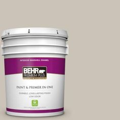 the behr paint and primer in one is shown on a green background with white trim