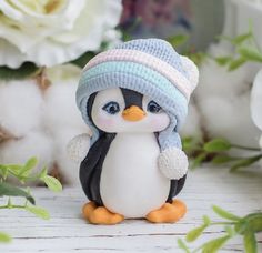 a small penguin figurine wearing a knitted hat