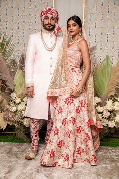 Mix and match your bridal and groomswear outfits with these modern red and pink floral wedding looks by Harleen Kaur. Ft. the Param Light Pink Sherwani styled with the Vihaan Red Floral Pants and a matching red floral Ishaan Turban for a dashing Indian groom outfit. Shop the red striped Zoe Top, metallic red floral Avni Lehenga Skirt, and sheer gold sequin Adhira Dupatta for a modern Indian bridal look! Find these indowestern made to order pieces online at www.harleenkaur.us!