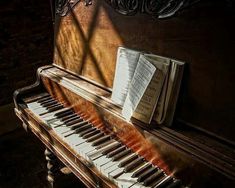 an old piano with sheet music on it