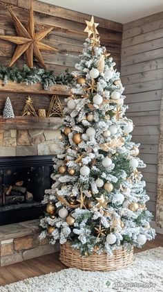 a decorated christmas tree in front of a fireplace with gold and silver ornaments on it