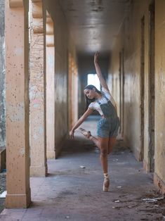 a young woman is dancing in an old building