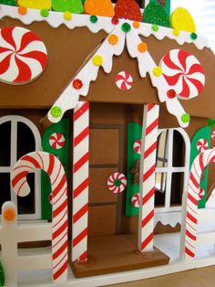 a gingerbread house is decorated with candy canes