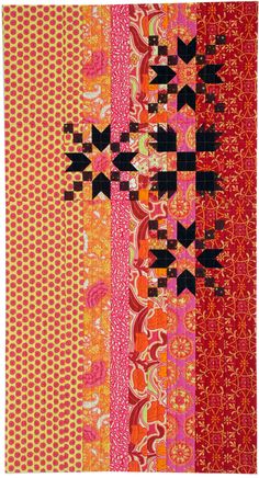 an orange and pink quilt with black crosses on it's sides, all in different colors