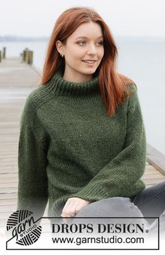 a woman is sitting on a dock wearing a green sweater and jeans, with the caption drops design