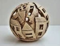 a ball that is made out of wood and has geometric designs on the outside of it