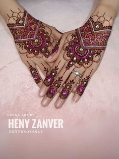 henna art by henny zaner on her hands with pink and white designs