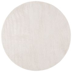 a white circular rug with wavy lines on it