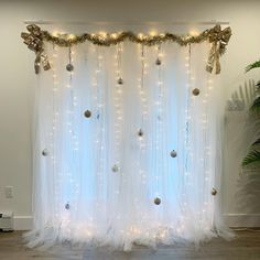 a white curtain decorated with lights and ornaments