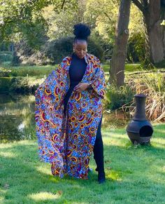 African print duster in a multi-coloured floral print. It has deep side splits and comes with a wide belt in the same fabric and can be worn with or without the belt. Wrap up securely with the same fabric belt or your favourite belt or wear as a throw on or cover up. May be dressed up or down to suit the occasion. Handmade in Ghana. 100% cotton. HAVE YOU CHECKED YOUR MEASUREMENTS AGANST THE SIZE CHART FOR THIS SHOP? Although we do our best to make sure that the colours displayed on our Website a Bohemian Belted Kimono With Kimono Sleeves, Bohemian Belted Kimono, Long Kimono With Vibrant Print For Festival, Floral Print Maxi Length Kimono For Festival, Maxi Length Floral Kimono For Festival, Festival Floral Print Maxi Kimono, Spring Long Belted Kimono, Floral Print Kimono Sleeves Outerwear For Festival, Long Patterned Kimono With Floral Print