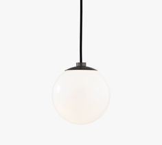 a black and white light hanging from a ceiling fixture with a round glass ball in the center