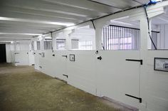 the inside of a building with white walls and doors on each side of the wall