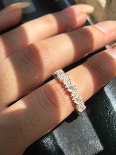 a woman's hand with a diamond ring on it