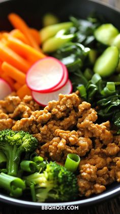 a bowl filled with broccoli, carrots and other vegetables