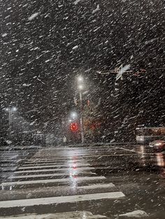 a cross walk in the snow at night