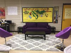 a purple couch and chairs in a room