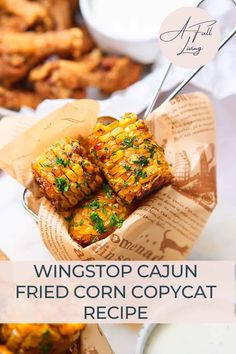 corn on the cob is served in a basket with text that reads, wingstop cajun fried corn copycat recipe