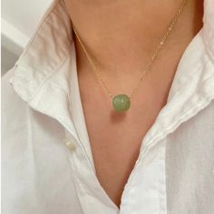 Tap into the spiritual properties of Nephrite Jade with our Ariana pendant necklace. This beautiful stone is known for promoting balance and inner peace, while also providing protection against negative energy and attracting love and money. Embrace abundance and harmony with this valuable jade pendant. 16 inches long + 2 inches ext 18K PVD gold plated stainless steel Nephrite Jade Non Tarnish And Water Resistant Holistic Jade Jewelry For Meditation, Jade Amulet Necklace With Round Pendant, Jade Round Pendant Necklace For Healing, Jade Pendant Necklace With Natural Stones, Round Jade Spiritual Necklaces, Spiritual Round Jade Necklaces, Round Jade Necklace For Spiritual Style, Spiritual Round Jade Necklace, Spiritual Jade Round Pendant Necklace