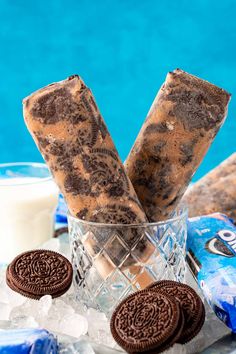 some cookies and ice cream are in a glass on the table next to a pool