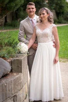 a bride and groom standing next to each other