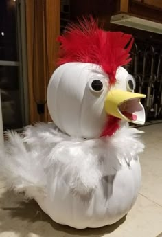 a white and red chicken sitting on top of a counter