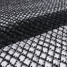 a black and white photo of some sort of fabric with small holes in the middle