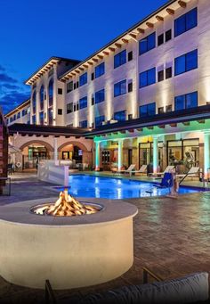 an outdoor fire pit in front of a hotel