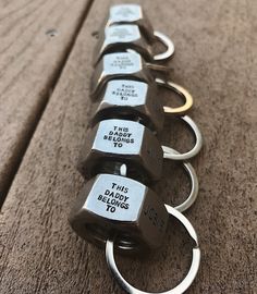 a row of keys that are sitting on top of a wooden table with metal handles