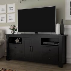 a flat screen tv sitting on top of a black entertainment center