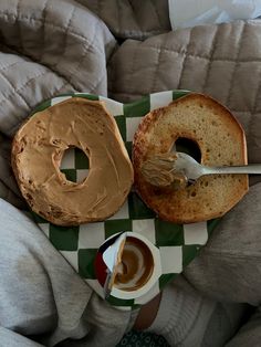 a bagel with peanut butter and a cup of coffee