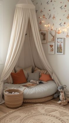 a canopy bed in a child's bedroom with pillows and blankets on the floor