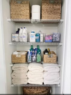 an organized bathroom closet with baskets and toiletries