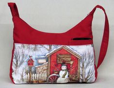 This is a medium size shoulder bag.  A great bag for Christmas and the winter season.  The bag measures 8 inches deep and 12 inches wide.  The strap is 33 inches long and 1 inch wide and has a non slip tab to keep it from slipping.   The inside lining is a lite color lining with 2 pockets, one is zippered.  The fabric is an upholstery weight cotton fabric.  It can be cold water washed.   The mobile phone pocket is large enough for any phone. Winter Purse, Christmas Purse, Winter Purses, Beautiful Handbags, Color Lines, Christmas Winter, Fabric Bag, Back Pocket, Red Fabric