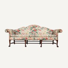 an old fashioned couch with floral upholstered fabric