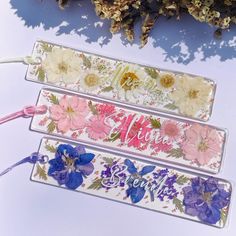 three flowered glass bookmarks sitting next to each other